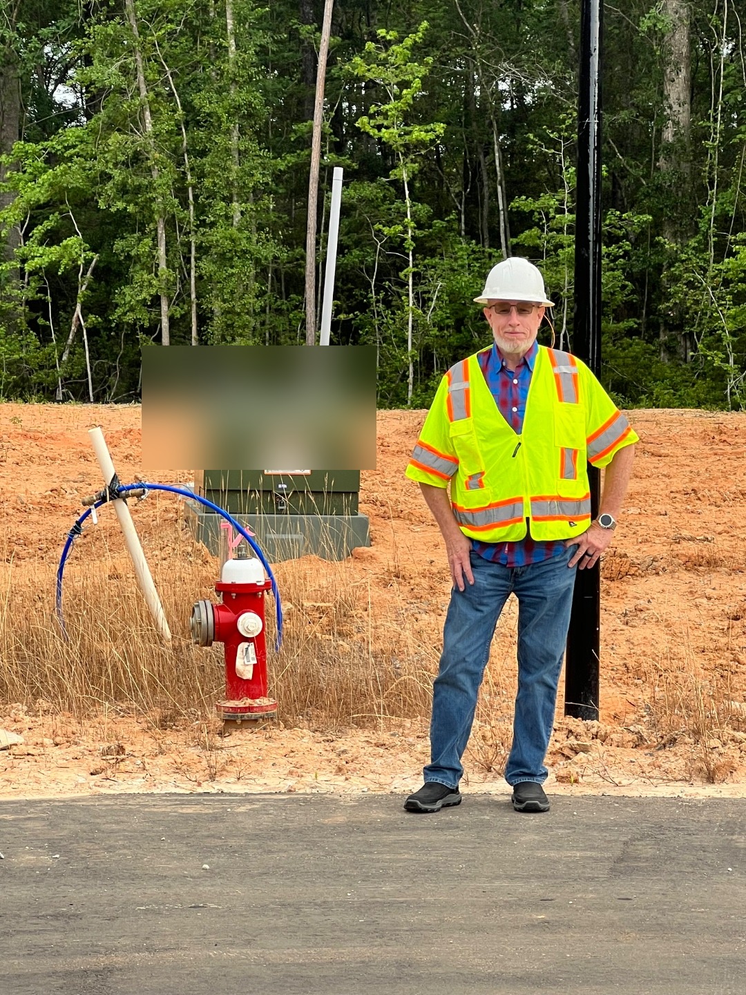 David Self on an active subdivision job site with hydrant and fresh utility installations